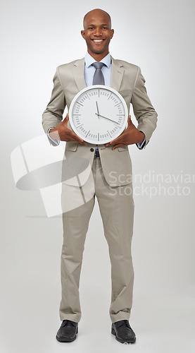 Image of Businessman, portrait and clock time for deadline as professional lawyer for schedule, hurry or punctual. Black person, face and white background in studio for company job efficient, hour or mockup