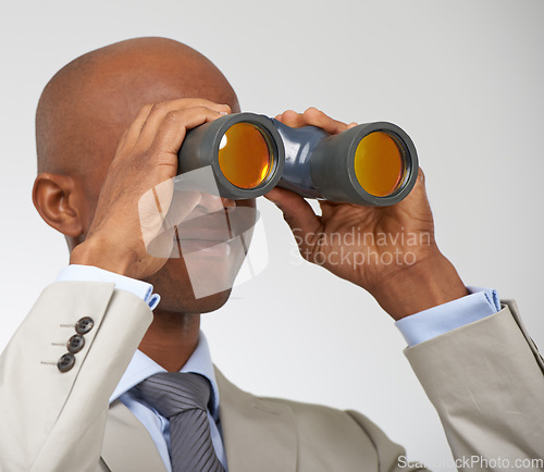 Image of Businessman, searching and career opportunity with binoculars in studio for job, professional or white background. Male person, smile and employment future growth or mockup space, search or corporate