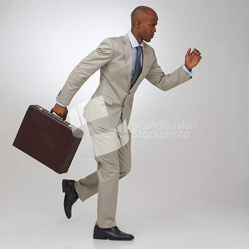 Image of Businessman, briefcase and running in studio as lawyer or late meeting, time management or corporate. Male person, rush and white background as professional or job employment, competition or mockup