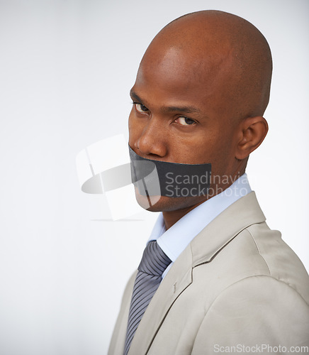 Image of Businessman, portrait and tape on mouth silence or corporate censored for secret, blackmail or quiet. Black person, face and journalist in company career trouble or white background, studio or mockup