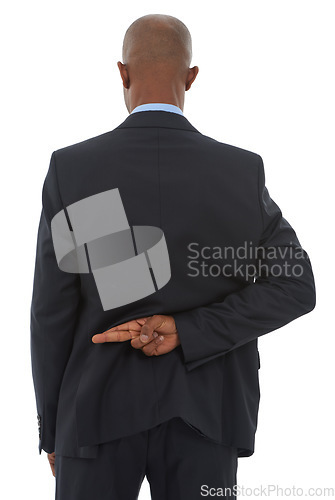 Image of Crime, lie and fingers crossed with business man in studio isolated on white background for secret or deception. Corporate, fraud and african employee with hand behind back for lying or corruption