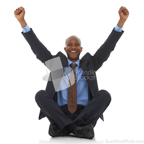 Image of Happy businessman, portrait and fist pump for promotion, bonus or celebration on a white studio background. Excited black man or employee smile sitting on floor for winning, achievement or promo deal