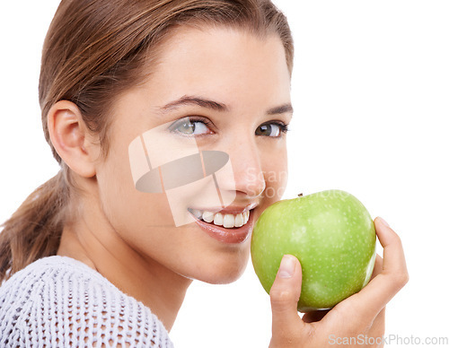 Image of Woman, portrait and eating apple, nutrition and gut health with snack or meal, diet for weight loss on white background. Healthy food, wellness and fruit, vegan and organic with smile in studio