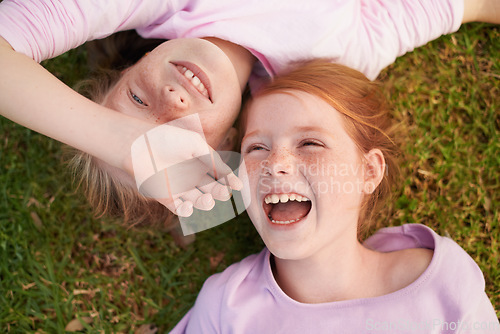 Image of Grass, happy kids or sisters laughing in park for bond, holiday or play together for support or joy. Top view, relax or funny children siblings in field with smile, love or friendship in a garden