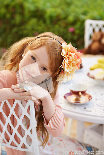 Image of Girl, child and tea party with happiness in garden with portrait for birthday, celebration and playing outdoor. Person, kid and face in backyard of house with dress up, beverage and role play fun