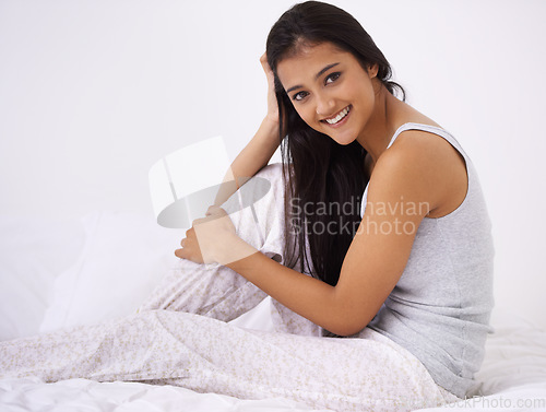 Image of Woman, bed and smile portrait in the morning happy to relax from rest and sleep in a home. Indian female person, bedroom and wake up on duvet with peace and calm in a house on a blanket with comfort