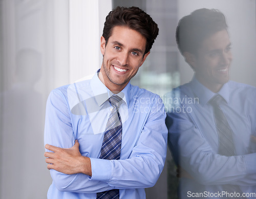 Image of Window, crossed arms and portrait of businessman in workplace with confidence, pride and ambition. Corporate entrepreneur, professional and happy worker for career, job and working in modern office