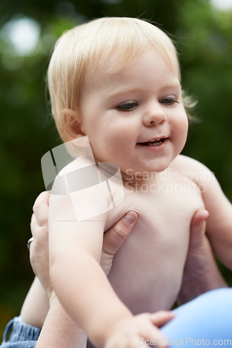 Image of Baby, person and playing outdoor for development with nurture, relationship and bonding for happiness. Family, child or toddler and hands with early childhood, parenting and love at park in nature