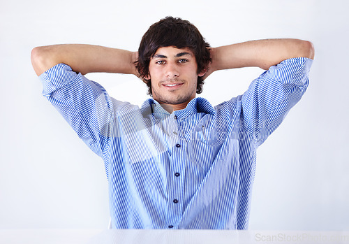 Image of Happy man, portrait and relax at office on break for done, completion or finished on a white studio background. Face of young handsome male person or employee in rest with blue clothing or fashion