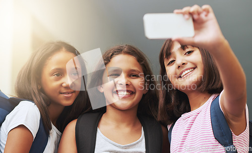 Image of Friends, children and smile for selfie in elementary school, educational memory and learning together. Diversity, young students and group of girls taking picture for social media, photography or fun