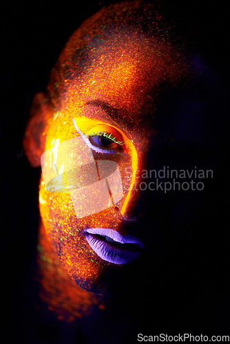 Image of Portrait, fantasy and creative with neon woman on black background for makeup, glitter or colorful glow. Face, art and beauty with confident young person in the dark for psychedelic or techno paint