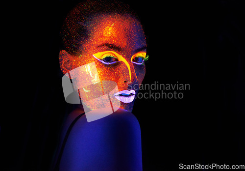 Image of Portrait, art and creative with neon woman on black background for makeup, glitter or colorful glow. Face, fantasy and beauty with confident young person in the dark for psychedelic or techno paint