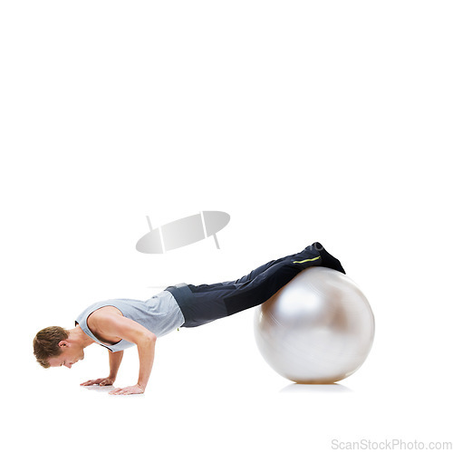 Image of Man, push ups and exercise ball for fitness, workout or health and wellness against a white studio background. Active male person or athlete on round object for training or pilates on mockup space