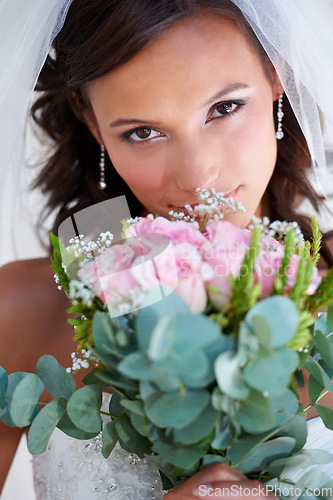 Image of Bride woman, bouquet and portrait at wedding with flowers, pride and commitment at event, celebration and party. Girl, marriage and floral plants for love, roses or scent with bush, nature or memory