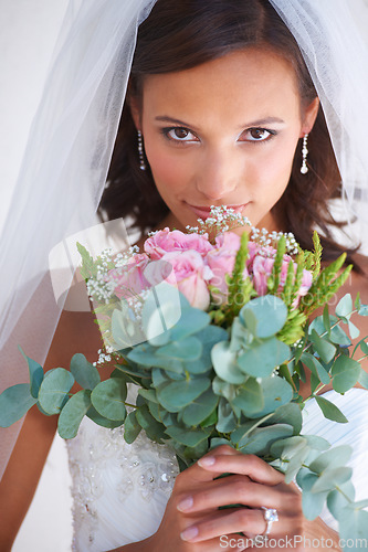 Image of Woman, portrait and flower bouquet in wedding dress for marriage commitment, love promise or diamond ring. Female person, face and plant or veil for pride romance, partnership or celebration event