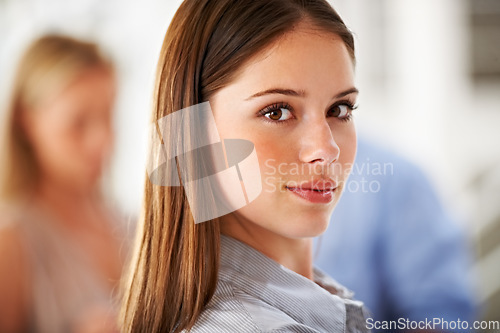 Image of Portrait, face and internship with a business woman in her office on a blurred background for career. Professional, serious and confident with a young employee closeup in workplace of a design agency