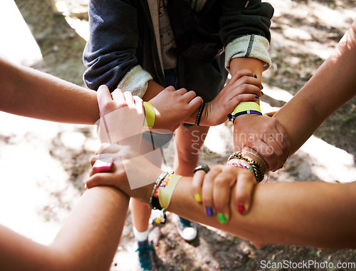 Image of People, hands together and outdoor festival with arm bands for community, teamwork or unity at event. Group of friends piling or circle for synergy, motivation or party at music carnival outside