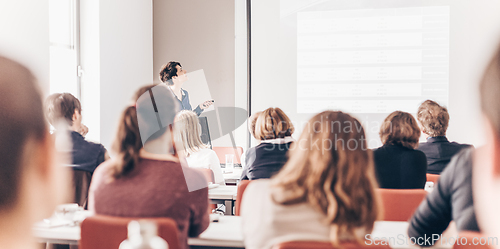 Image of Woman giving presentation in lecture hall at university.