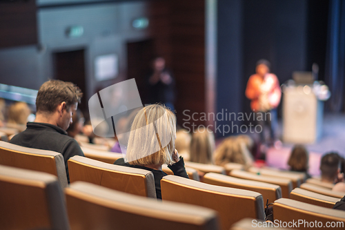 Image of Woman giving presentation on business conference event.