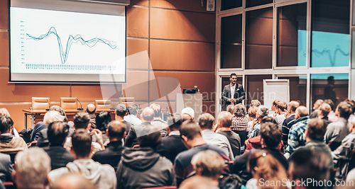 Image of Business speaker giving a talk in conference hall.