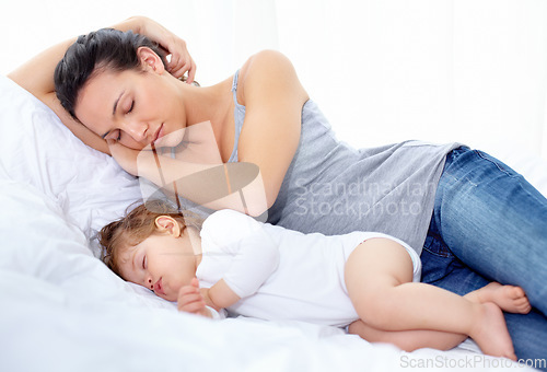 Image of Mother, baby and sleeping on bed together for calm break, peace and dreaming to relax at home. Tired mom, young kid and asleep for newborn development, healthy childhood growth and cozy nap for rest