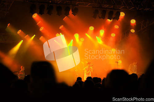 Image of Crowd silhouette, music band and concert audience listen to club artist, stage performance or celebrity star. Night event lights, rave festival and dark shadow group, fans or people at musician show