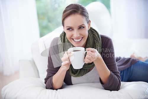 Image of Coffee, thinking and happy woman relax on a sofa with memory, moment or reflection in her home. Tea, break and female person in a living room with comfort, beverage or day off, me time or self care