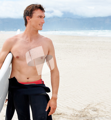 Image of Thinking, space and shirtless man with surfboard on beach in wetsuit for travel, exercise or fitness. Nature, summer and body of young surfer on blue sky by ocean or sea with sand for sports training