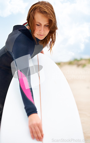 Image of Beach, cleaning or woman with surfboard on vacation or adventure for fitness, wellness or travel. Athlete, surfer or ready to start surfing at sea on holiday in Hawaii or ocean in extreme sports