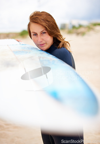 Image of Beach, holding or woman with surfboard on vacation for fitness training, wellness or travel. Athlete, surfer cleaning or ready to start surfing at sea on holiday in Hawaii or ocean in extreme sports