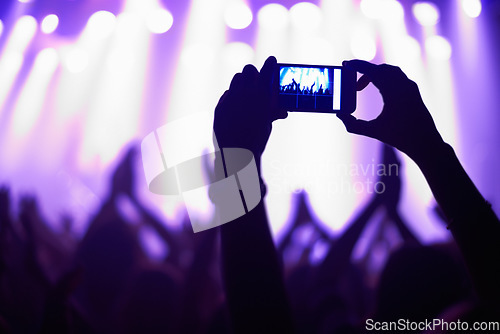 Image of Nightclub, concert and audience with phone or lights for music, party and rave festival with silhouette and dancing. Disco, psychedelic event or performance with entertainment, crowd and smartphone