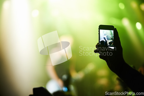 Image of Nightclub, festival and audience with phone or lights for music, party and rave concert with silhouette and band. Disco, psychedelic event and performance with entertainment, crowd and smartphone