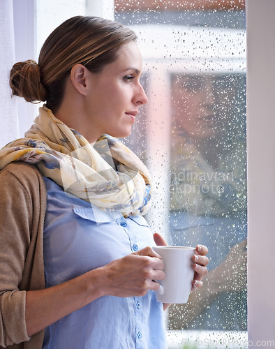 Image of Woman at window, thinking with tea and reflection, life and future in morning routine, raindrop and wellness. Insight, memory and mindfulness with warm beverage, coffee break and relax at home