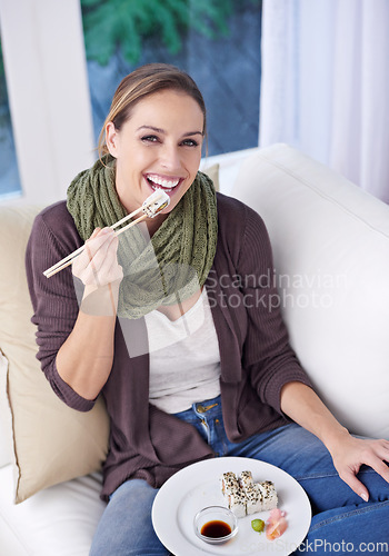 Image of Woman, eating sushi and food in living room, portrait with lunch or dinner, Japanese cuisine and seafood with chopsticks. Catering, hungry and diet, relax with meal at home and dish for nutrition