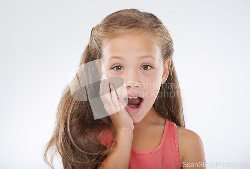Image of Child, portrait and hand for surprise news in studio for announcement, information or review. Female person, face and shocked on white background for giveaway secret as wow mockup, winner or drama