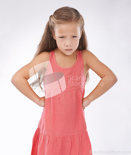 Image of Portrait, unhappy or tantrum and girl child in studio on white background with anger and frustration. Cross, problem or moody and young kid with bad attitude looking upset at problem or mistake