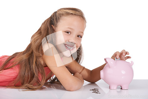 Image of Girl child, piggy bank and coins for portrait, studio and pride with smile for investing by white background. Kid, container or animal toys with relax for money, cash or happy for financial education