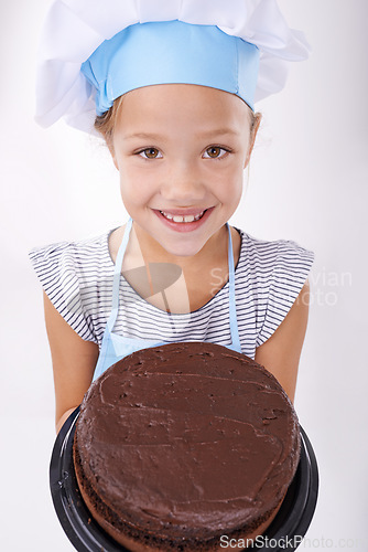 Image of Kid, baker and portrait with cake, happy and confident with child development on white background. Culinary skills, satisfied and baking dessert and childhood with chocolate in hospitality industry