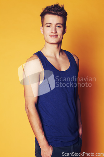 Image of Fashion, smile and portrait of man in studio with trendy, cool or summer clothes on orange background. Face, style and male model with confidence, personality or casual, streetwear or outfit choice