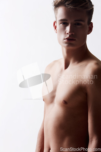 Image of Portrait, natural and masculine with shirtless man in studio on white background for health or wellness. Aesthetic, skin or stomach and body of fresh young model in for hygiene and satisfaction