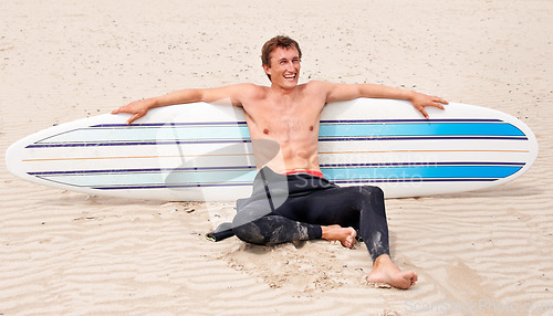 Image of Relax, vision and laughing man with surfboard on beach in wetsuit for sports, travel or fitness. Thinking, smile and body of young surfer on sand by ocean or sea for break from training and exercise