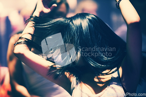 Image of Dance floor, club and woman with energy, hair and freedom, music and fun celebration. Party, concert and female person in a crowd with movement, motion and good vibes at festival, event or nightclub