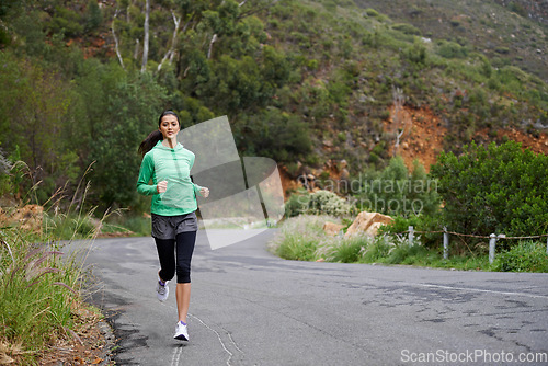 Image of Running, fitness and woman on road on mountain for training, workout and exercise outdoors. Sports, nature and person on street for competition, race and challenge for health, wellness and cardio