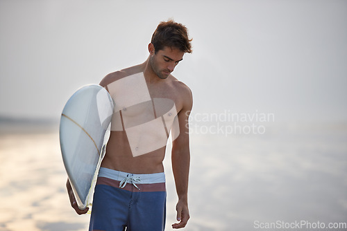 Image of Nature, surfing and man with surfboard at beach for, waves on summer vacation, weekend and holiday by sea. Travel, walking and person by ocean for water sports, adventure and hobby in Australia