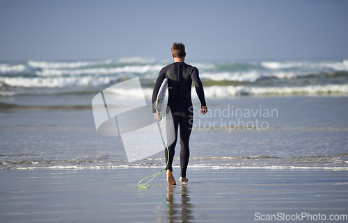 Image of Ocean, surfing and man with surfboard at beach for waves on summer vacation, weekend and holiday by sea. Travel, nature and back of person running for water sports, adventure and hobby in Australia