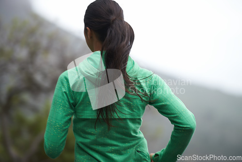 Image of Back, road and running with woman, energy and morning with endurance and exercise for health, wellness and cardio. Person, runner or athlete with workout or training with nature, morning or challenge