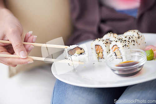 Image of Hands, sushi plate and chopsticks in closeup, home or eating for wellness, diet or meal with soy sauce. Hungry person, fish and dish at lunch, nutrition or snack for takeaway food, house or apartment