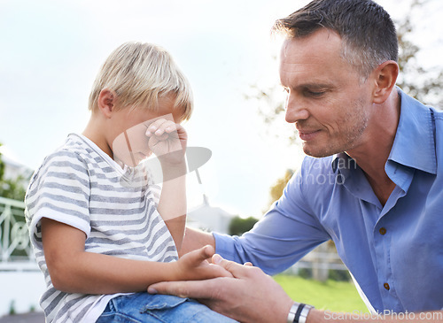 Image of Crying, comfort and dad outside with child, pain and help with emotional boy in garden of home. Love, support and tears, sad kid and dad in backyard with empathy, injury and care for childhood stress