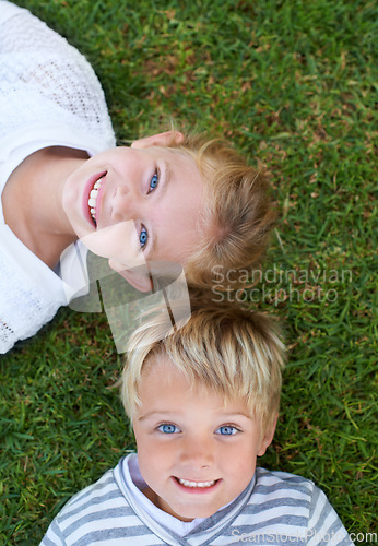 Image of Smile, portrait of girl and boy on grass together for bonding, outdoor fun and kids from above. Happiness, lawn and face of children in backyard on weekend for playful development, growth and care.
