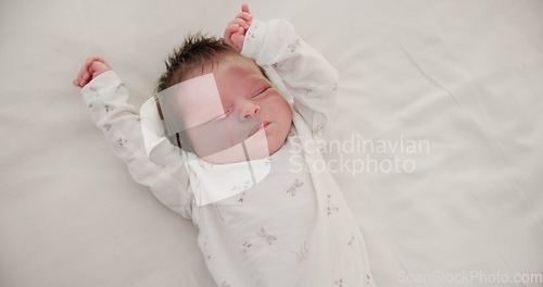 Image of Newborn, face or sleeping with stretching on bed in nursery for relaxing or resting with child development. Baby, tired or dreaming in bedroom of house with calm, relax and cute infant in family home